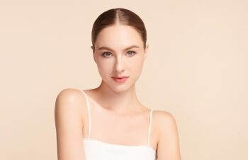 Beautiful young woman with clean fresh skin on beige background, Face care, Facial treatment, Cosmetology, beauty and spa, women portrait.