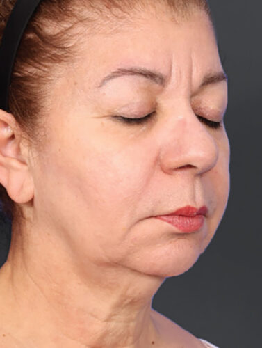 A profile view of a woman with her eyes closed.